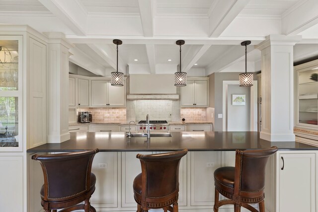2S546 Heaton Dr, Batavia, IL 60510 - kitchen featuring decorative columns, dark countertops, a sink, tasteful backsplash, and beam ceiling