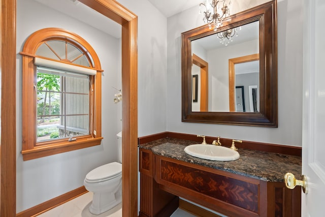 2S546 Heaton Dr, Batavia, IL 60510 - half bath with toilet, vanity, a chandelier, and baseboards
