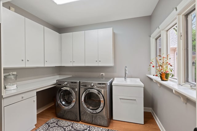 2S546 Heaton Dr, Batavia, IL 60510 - laundry area with cabinet space, light wood finished floors, washing machine and dryer, and baseboards
