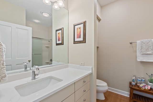 2S546 Heaton Dr, Batavia, IL 60510 - bathroom with toilet, a shower with shower door, wood finished floors, baseboards, and vanity