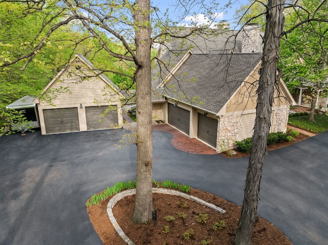 2S546 Heaton Dr, Batavia, IL 60510 - view of front of home featuring a shingled roof, a garage, stone siding, and driveway