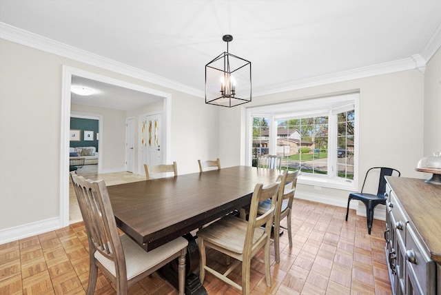 dining space with ornamental molding, a chandelier, and baseboards