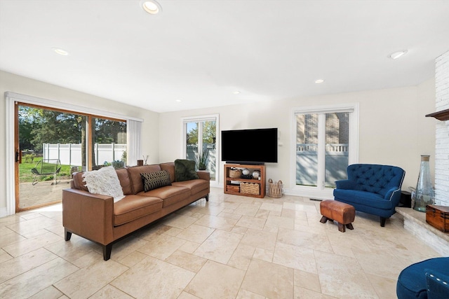 living area featuring a fireplace and recessed lighting