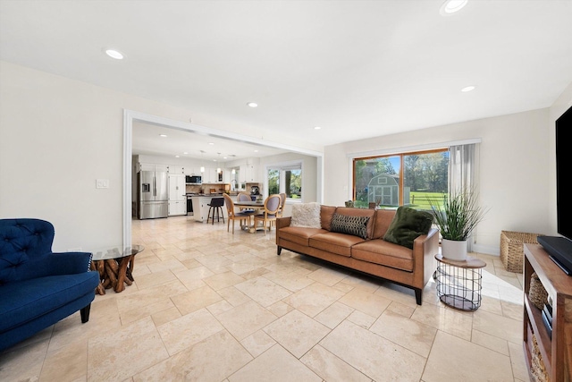 living room featuring recessed lighting and light stone finish floors