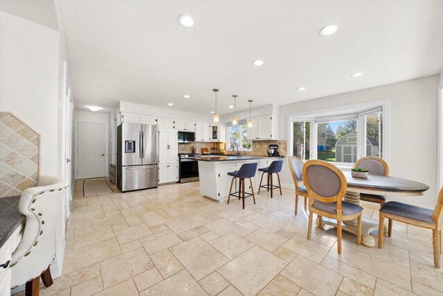 dining area featuring recessed lighting and stone tile flooring