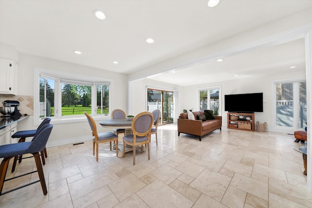dining space featuring recessed lighting, stone tile flooring, and baseboards