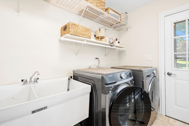 clothes washing area featuring separate washer and dryer and light tile patterned floors