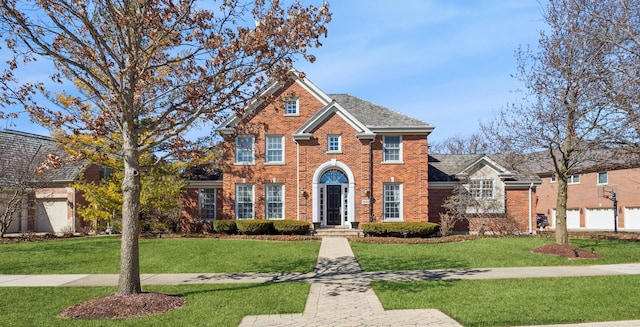 view of front of property featuring brick siding and a front yard