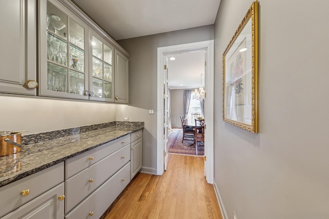 bar with baseboards and light wood-type flooring