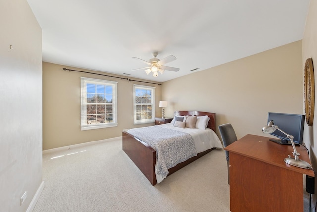bedroom featuring visible vents, a ceiling fan, baseboards, and light carpet