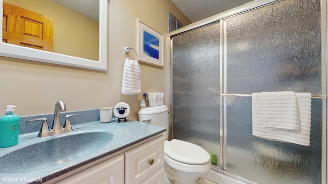 full bath with vanity, toilet, and a shower stall