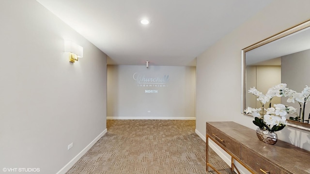 hall with recessed lighting and baseboards