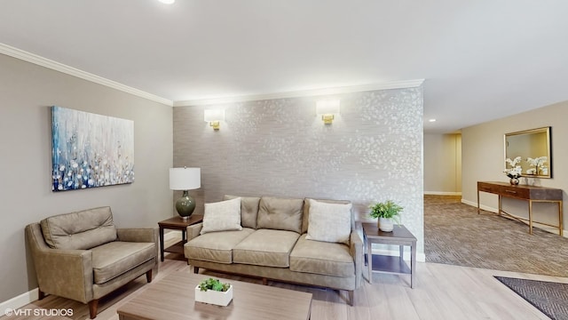 living area with an accent wall, recessed lighting, baseboards, wood finished floors, and ornamental molding