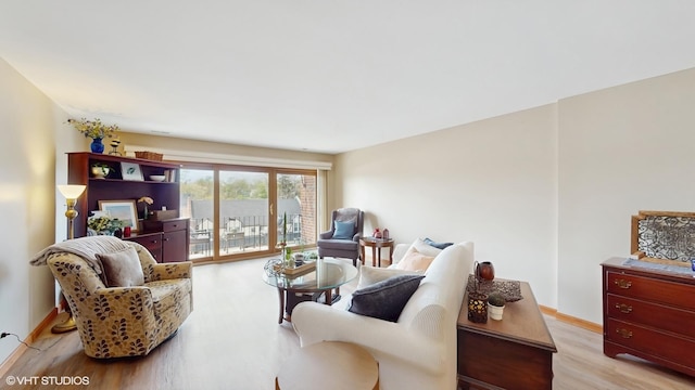living room featuring baseboards and wood finished floors