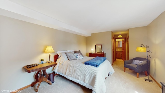 carpeted bedroom featuring baseboards and connected bathroom