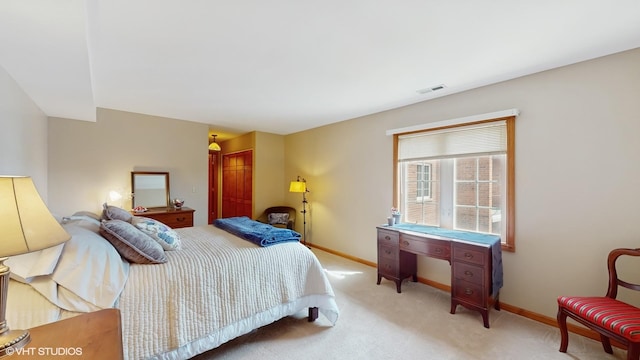bedroom featuring baseboards, light carpet, a closet, and visible vents