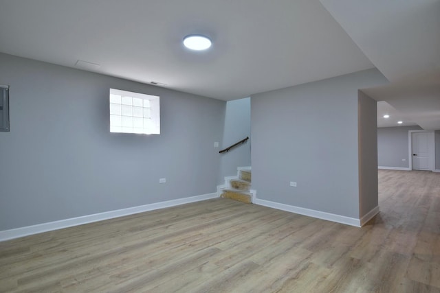below grade area with stairs, recessed lighting, baseboards, and wood finished floors