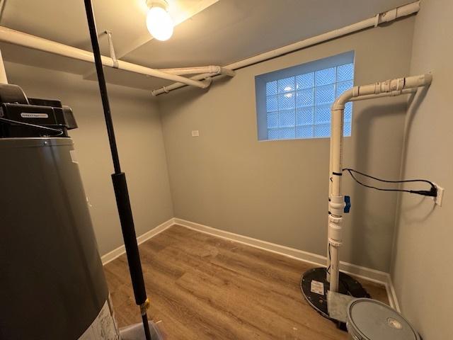 below grade area with baseboards and wood finished floors
