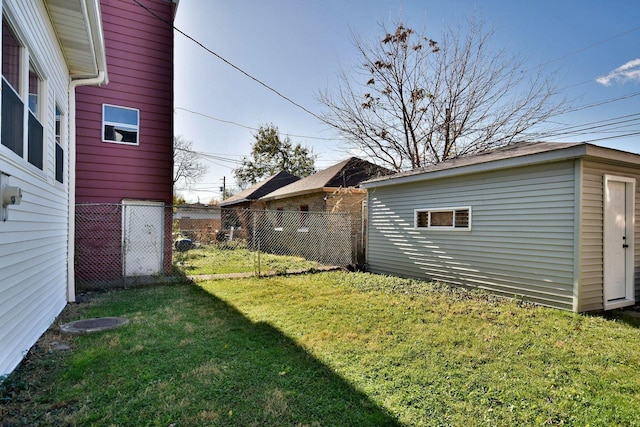 view of yard with fence and an outbuilding