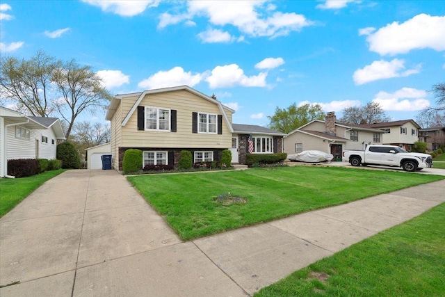 split level home with a front lawn and a garage