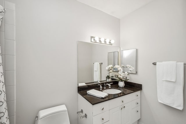 bathroom featuring vanity and toilet