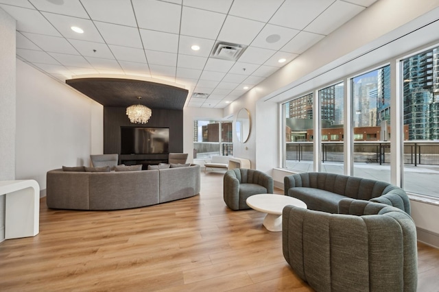 living room featuring visible vents, recessed lighting, a paneled ceiling, and light wood-type flooring