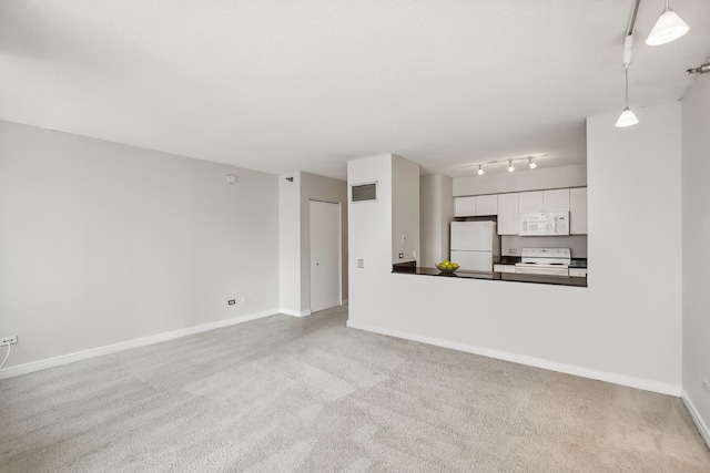 unfurnished living room with visible vents, carpet, and baseboards