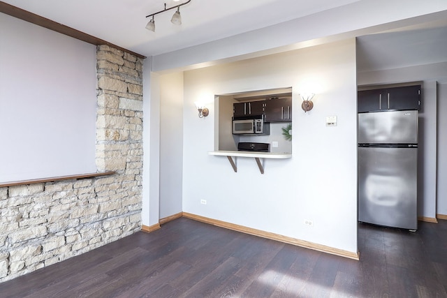 unfurnished living room with baseboards and dark wood-style floors