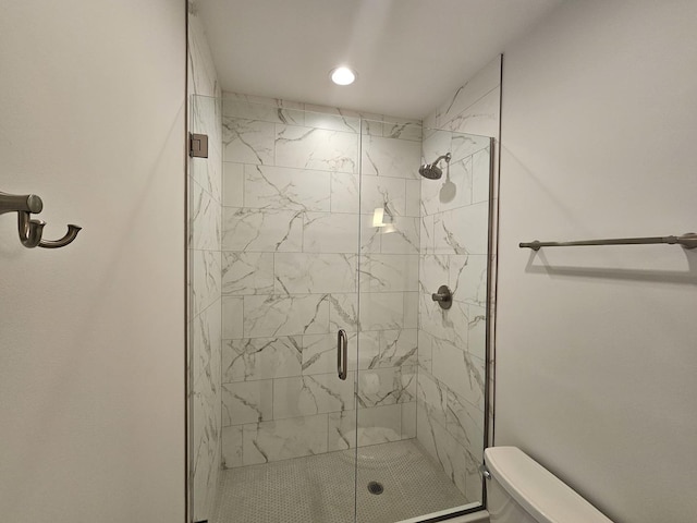 full bathroom featuring recessed lighting, a stall shower, and toilet