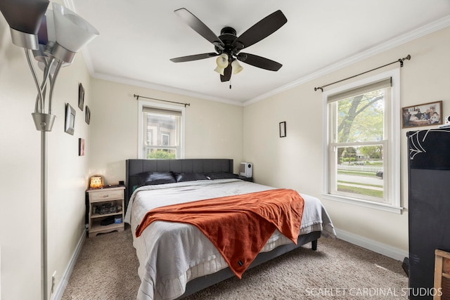 carpeted bedroom featuring crown molding, a ceiling fan, and baseboards