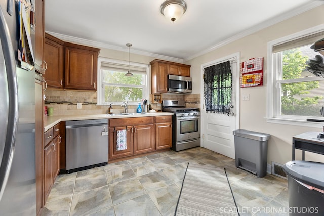 kitchen featuring decorative backsplash, brown cabinets, a sink, light countertops, and stainless steel appliances