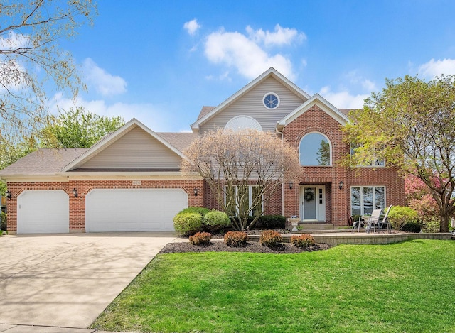 traditional-style house featuring a garage, a front lawn, concrete driveway, and brick siding