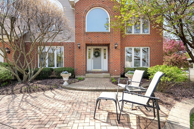 property entrance featuring brick siding