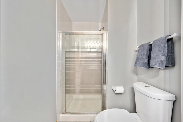 full bath with toilet and a shower stall