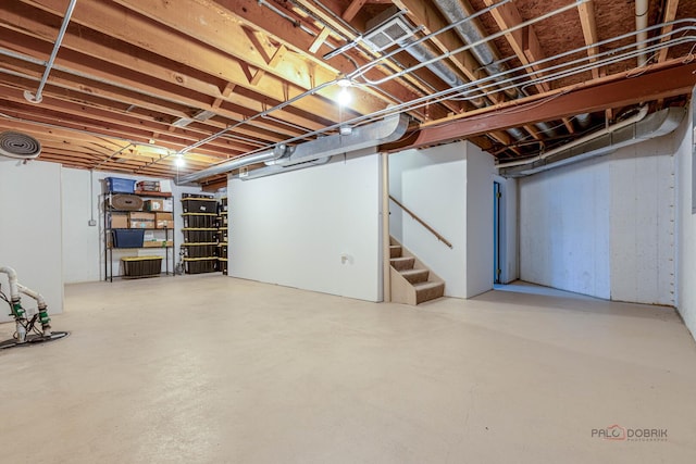 unfinished basement with visible vents and stairs