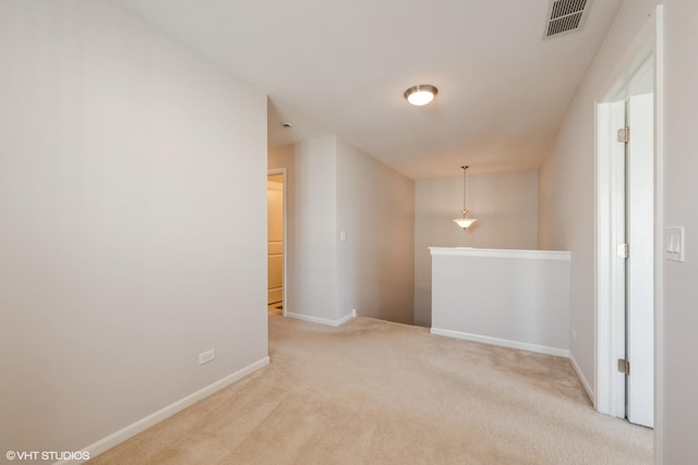 unfurnished room featuring carpet floors, baseboards, and visible vents
