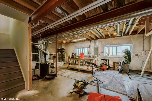 basement featuring stairway and electric panel
