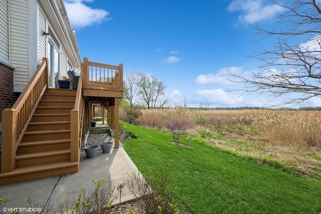view of yard featuring a wooden deck and stairway