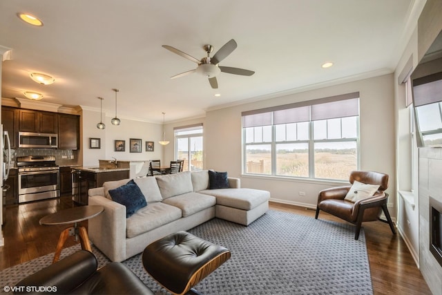 living area featuring ceiling fan, ornamental molding, recessed lighting, baseboards, and dark wood-style floors