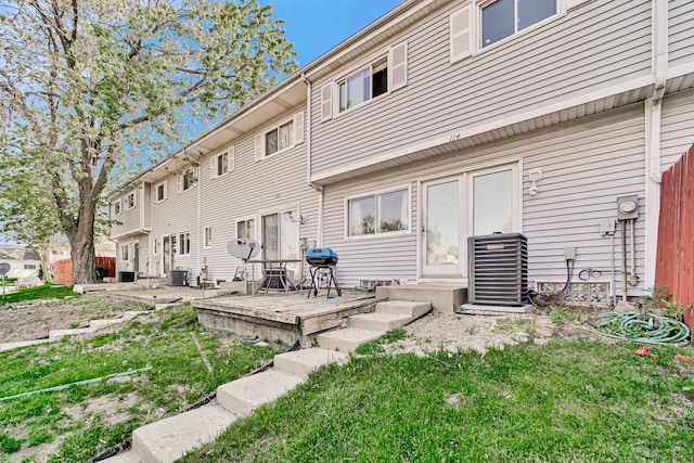 114 Pilgrim Ct, Bolingbrook, IL 60440 - rear view of house with central air condition unit, a wooden deck, and a yard