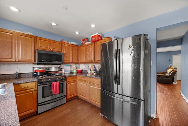 114 Pilgrim Ct, Bolingbrook, IL 60440 - kitchen featuring stainless steel appliances, wood finished floors, recessed lighting, dark countertops, and brown cabinets