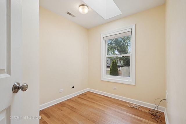 8712 N Central Ave, Morton Grove, IL 60053 - spare room with a skylight and wood finished floors