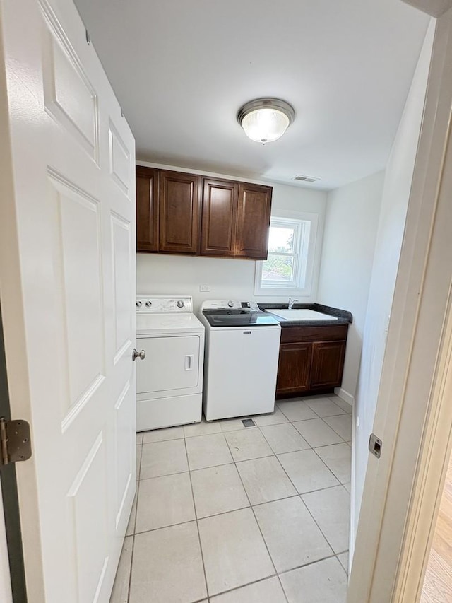 8712 N Central Ave, Morton Grove, IL 60053 - laundry area with cabinet space, washer and clothes dryer, and light tile patterned floors