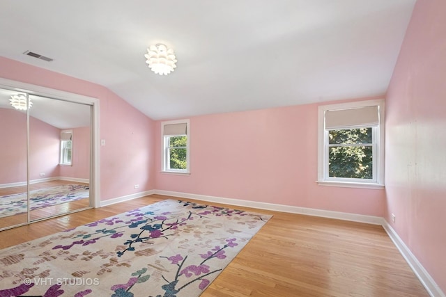 8712 N Central Ave, Morton Grove, IL 60053 - bedroom with vaulted ceiling, wood finished floors, multiple windows, and a closet