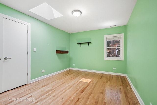 8712 N Central Ave, Morton Grove, IL 60053 - unfurnished room featuring a skylight and wood finished floors