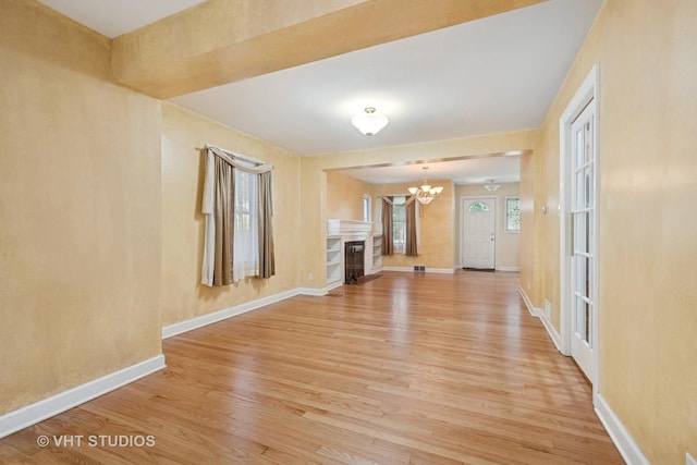 8712 N Central Ave, Morton Grove, IL 60053 - unfurnished living room with light wood-type flooring and a chandelier