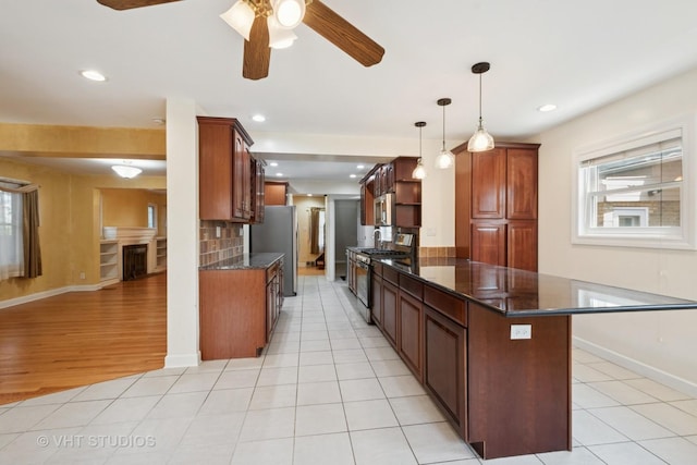 8712 N Central Ave, Morton Grove, IL 60053 - kitchen with stainless steel appliances, ceiling fan, a peninsula, dark stone counters, and recessed lighting