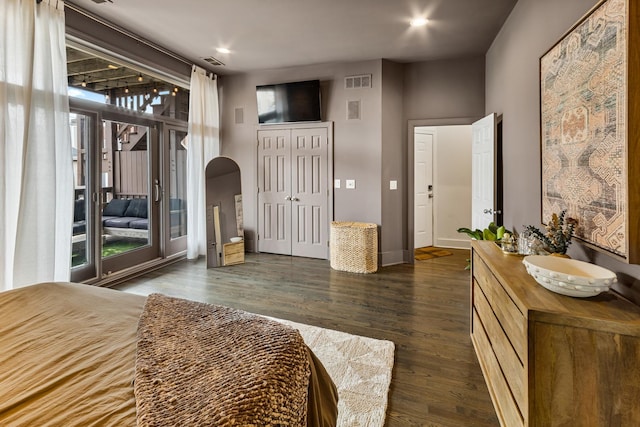 bedroom featuring visible vents, dark wood-type flooring, and access to outside