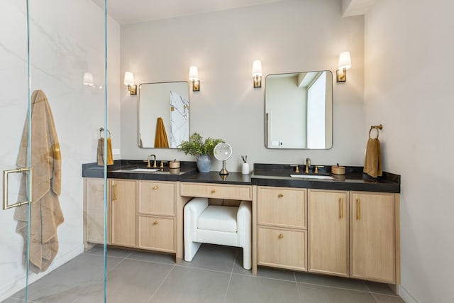 full bath with double vanity, a shower with door, a sink, and tile patterned flooring