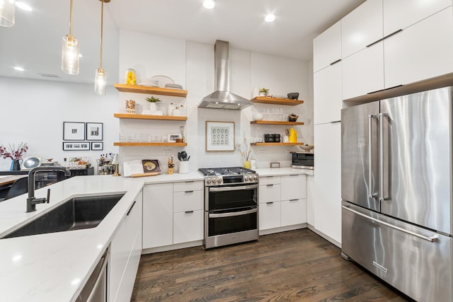 kitchen featuring open shelves, modern cabinets, wall chimney exhaust hood, a sink, and appliances with stainless steel finishes